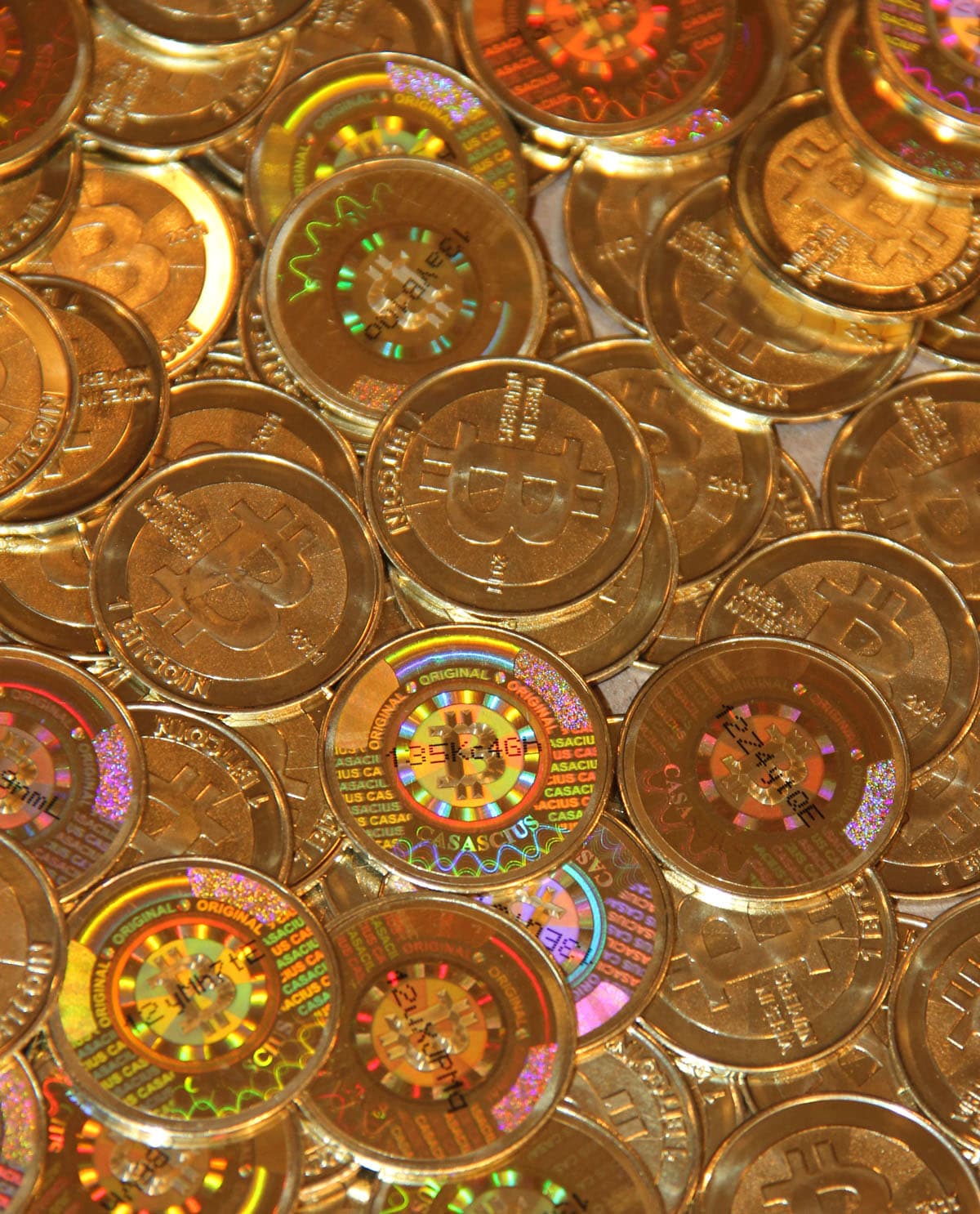 Physical Casascius bitcoin coins arranged on a surface
